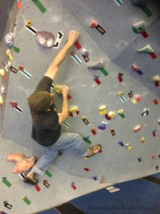 Photo of climber climbing at climbing gym