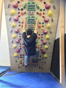 Photo of climber on system board at climbing gym